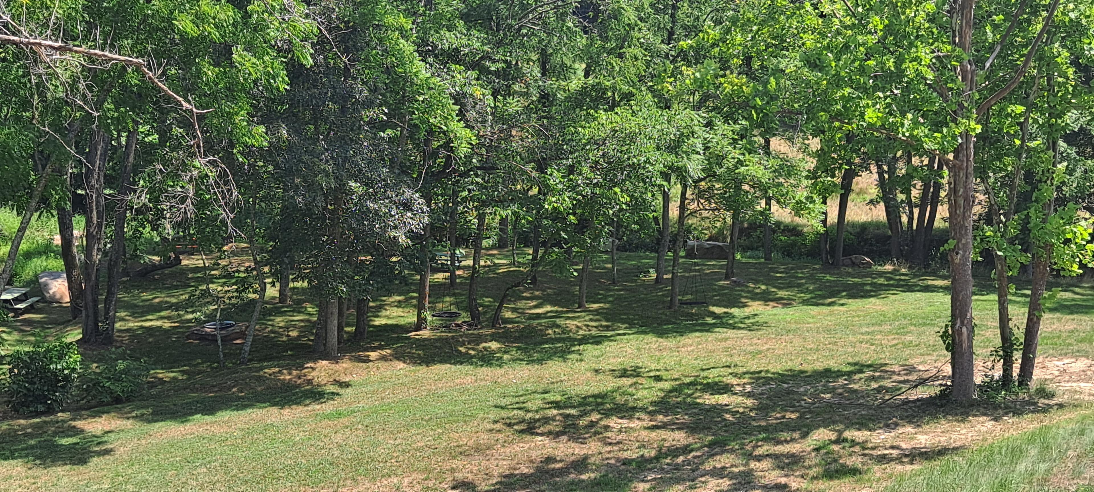 One of several picnic areas with swings, tables and creek access